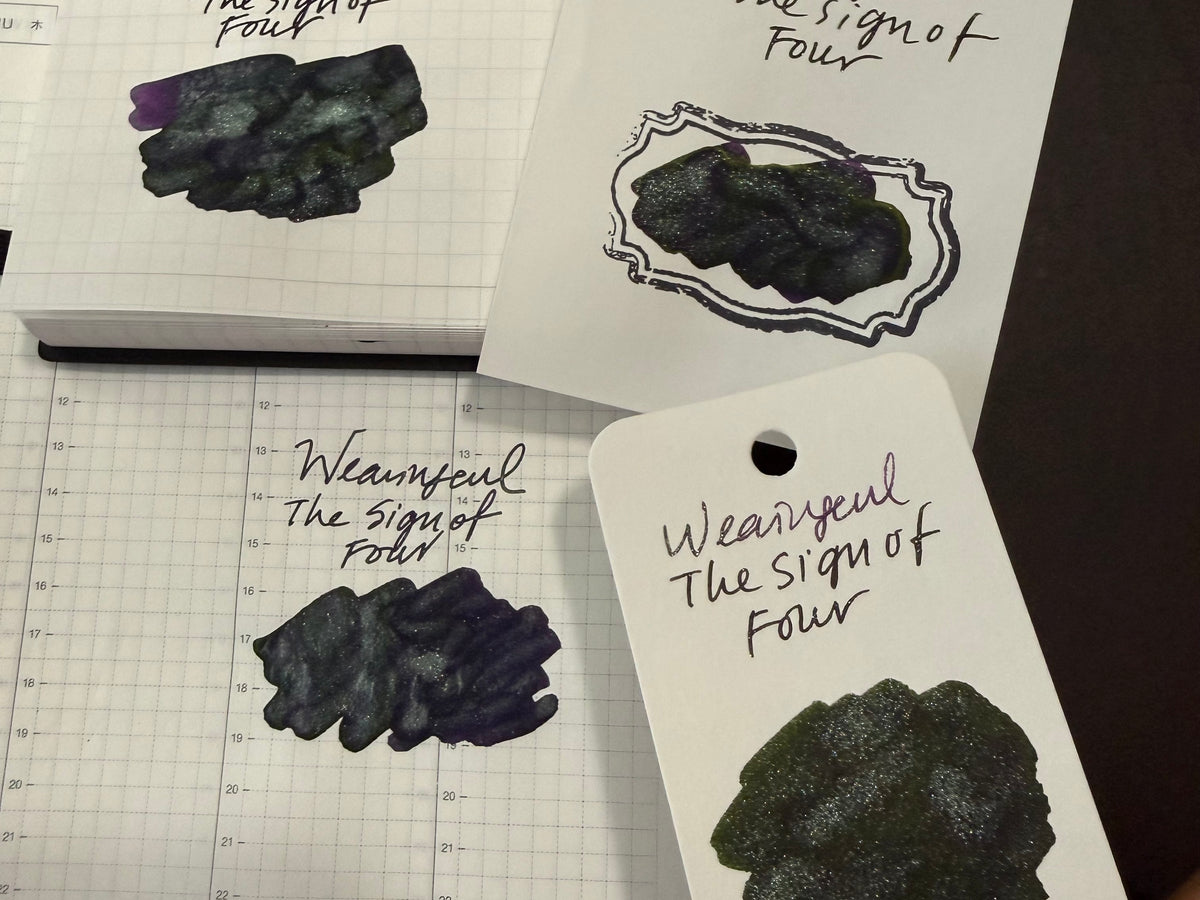 Wearingeul The Sign of Four ink swatched on four papers: MARK'S EDiT notebook, Tomoe River card, Col-o-ring card and Hobonichi Techo page, showing silver shimmer with green, teal and violet tones.