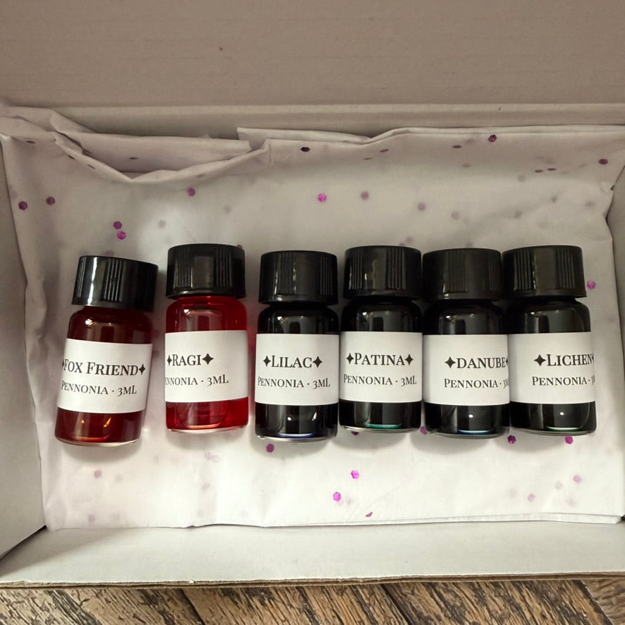 Close-up of the six labeled Pennonia ink vials: Fox Friend, Ragi, Lilac, Patina, Danube and Lichen