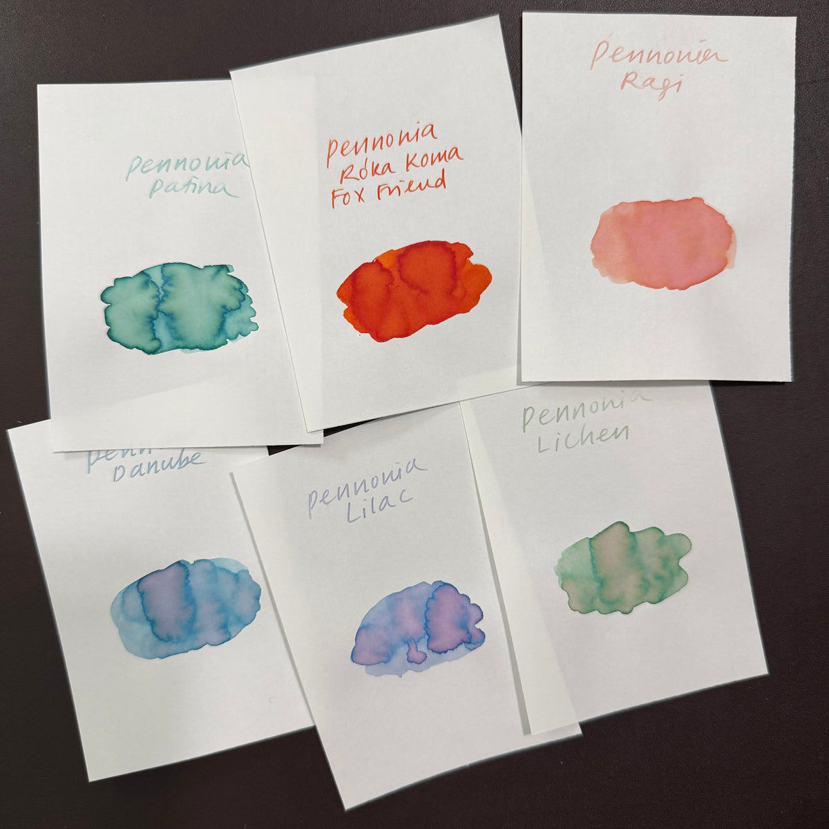 Handwritten swatch cards of the six Pennonia inks showing their shading: Patina, Roka Koma, Ragi, Danube, Lilac and Lichen