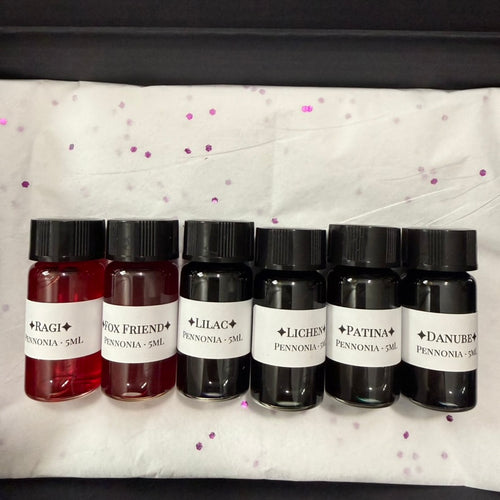 Close-up of the six labeled 5 mL Pennonia ink vials: Ragi, Fox Friend, Lilac, Lichen, Patina and Danube
