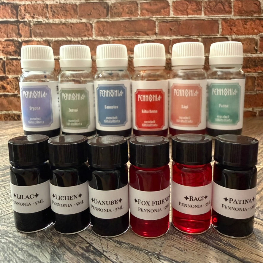 Pennonia Orgona, Zuzmo, Danuvius, Roka Koma, Ragi and Patina bottles behind the matching 5 mL sample vials