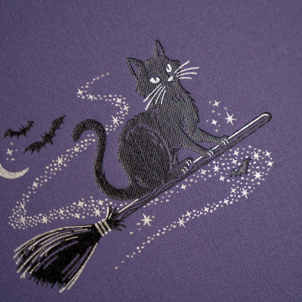 Archer & Olive Bewitched A5 notebook: Close-up of the black cat, broomstick, bats, and silver stars.