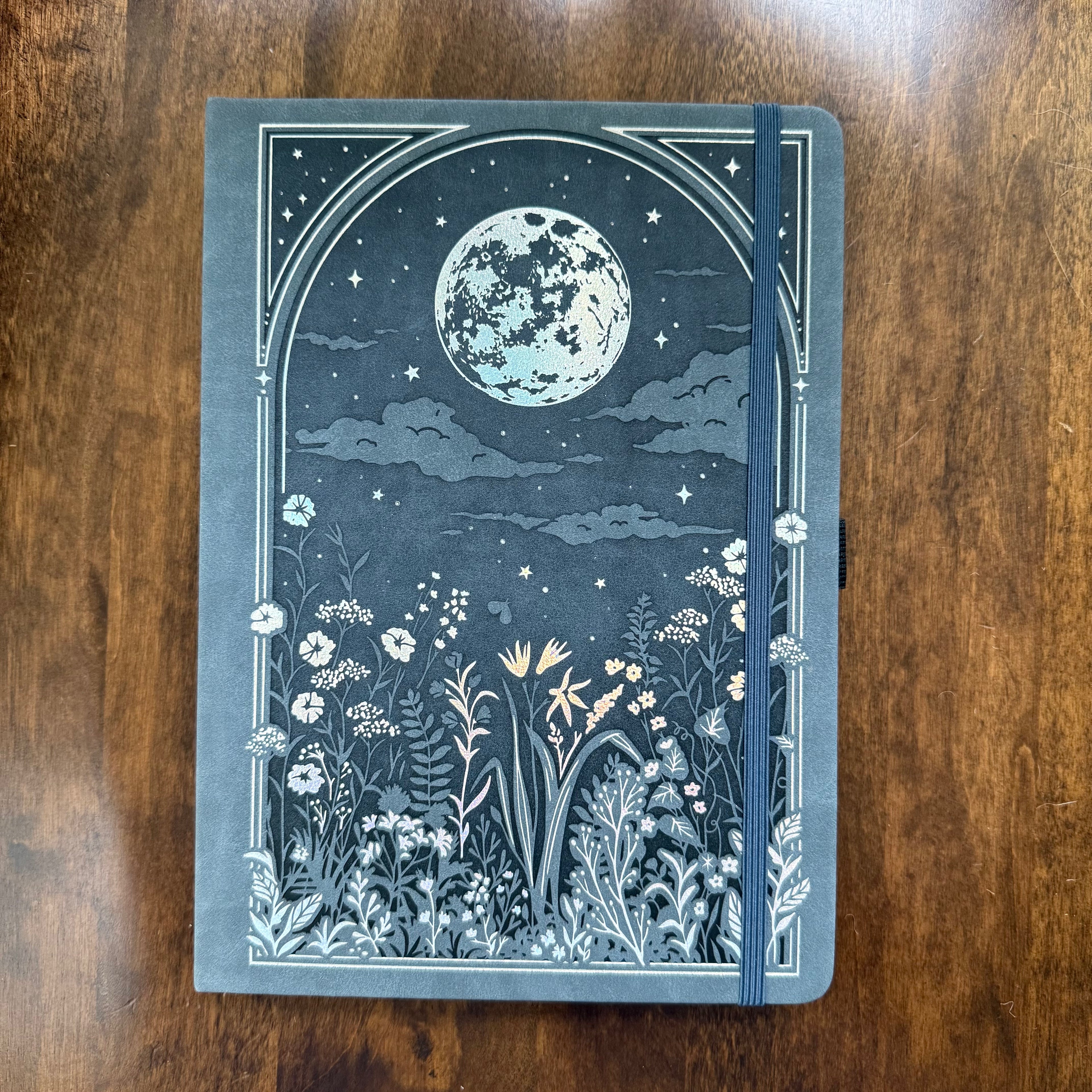 Archer & Olive blue-grey dot-grid notebook with moon and botanical cover design