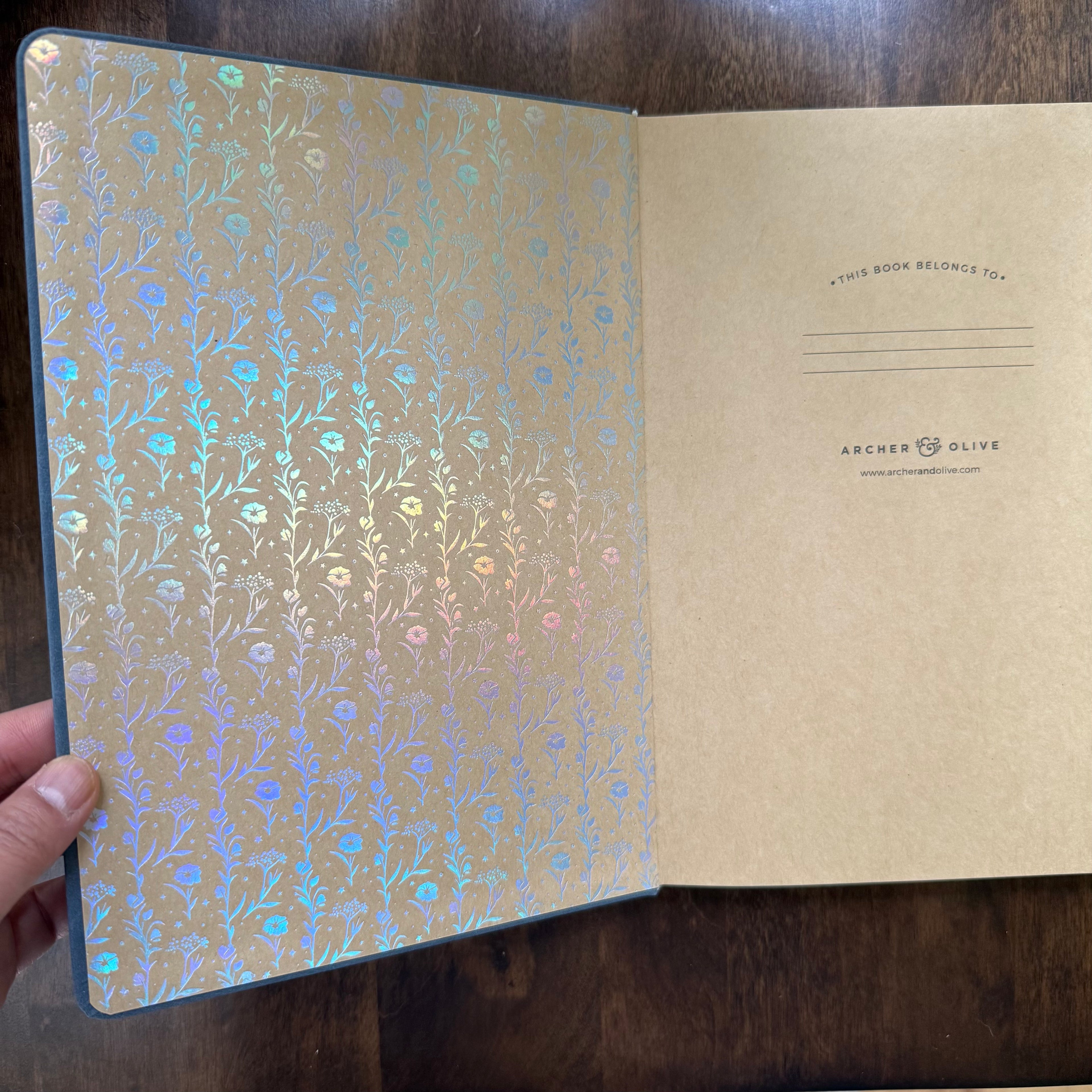 Archer & Olive blue-grey dot-grid notebook open to decorative endpaper and interior page