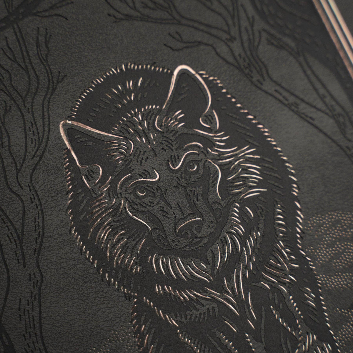 Archer & Olive Wolf in the Night A5 notebook: Close-up of the embossed wolf and metallic foil.