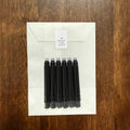 Six black short international fountain pen ink cartridges with Boston Lore Studio glassine envelope