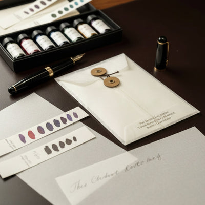 Boston Lore Studio Tomoe River ink swatch cards with a button-and-string glassine envelope, ink swatches, and fountain pen