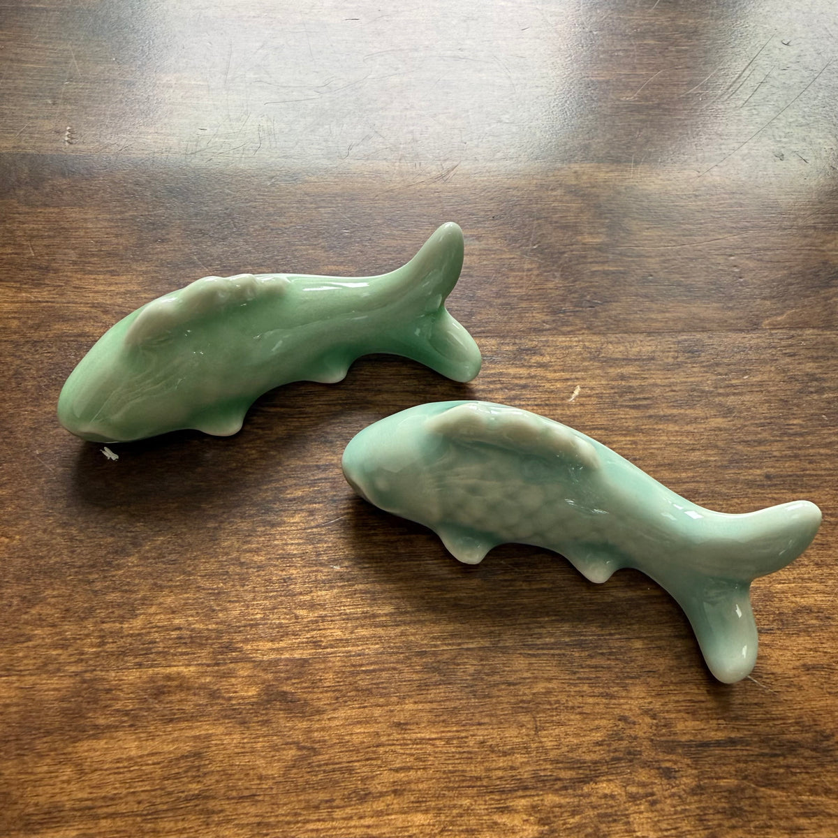 Jade Green and Celadon Cloud ceramic carp pen rests shown together for glaze comparison