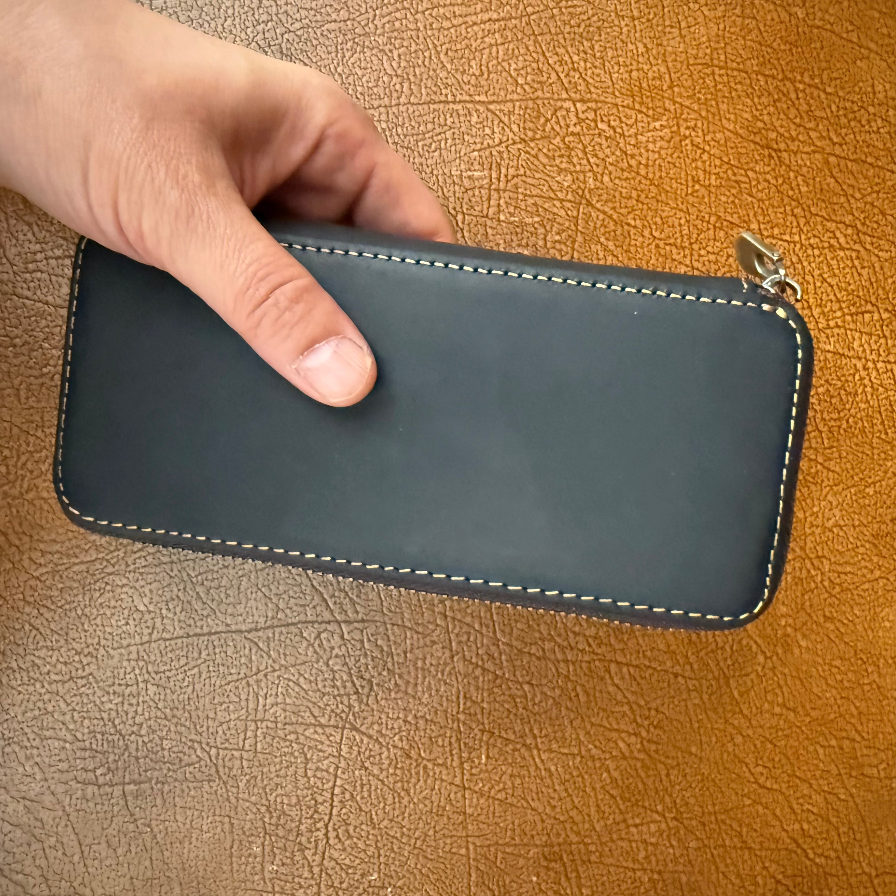 Black leather 3-pen fountain pen case held in hand for scale