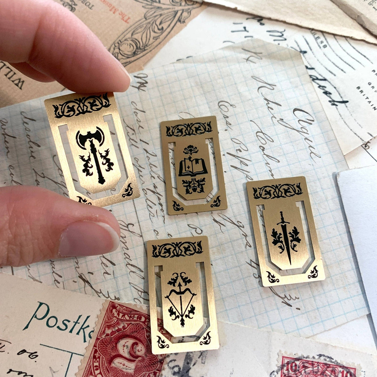 The Creeping Moon brass page markers shown in use