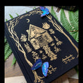 The Creeping Moon The Grimoire B6 notebook with black linen cover and gold foil design