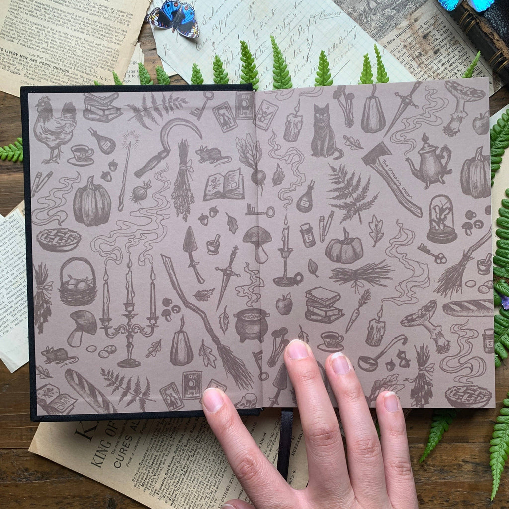 Illustrated endpapers inside The Creeping Moon The Grimoire B6 notebook
