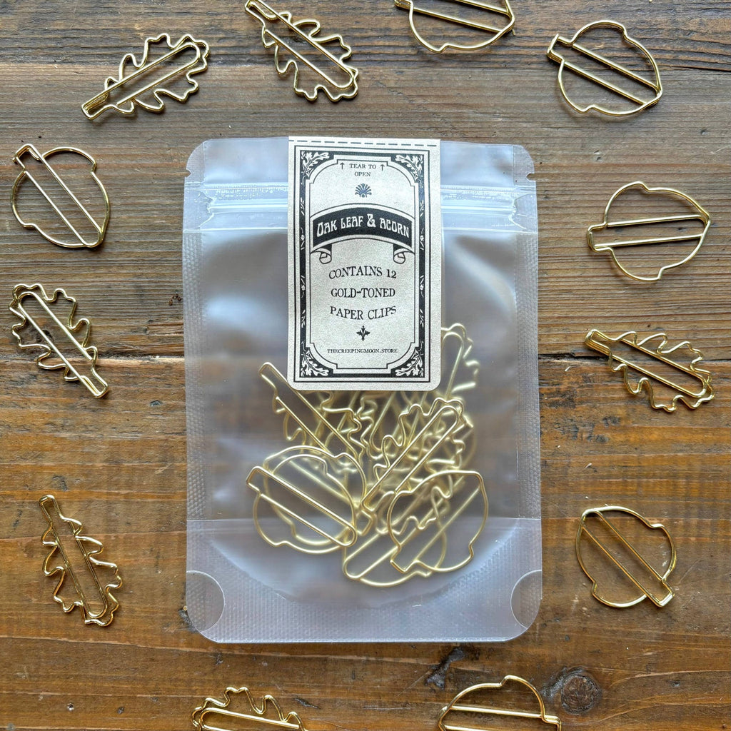 The Creeping Moon oak leaf and acorn paper clips shown with stationery