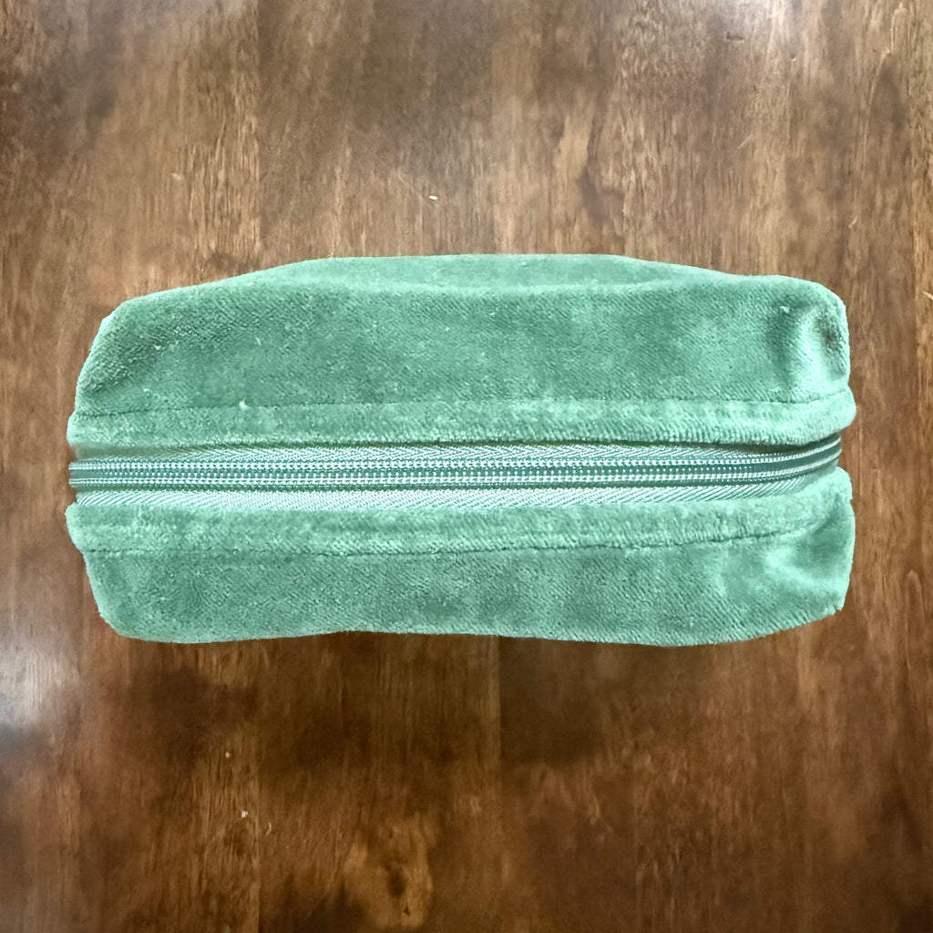 Top view of Danica Studio Wildgrove velvet pouch with zipper closure

Hand-held/detail