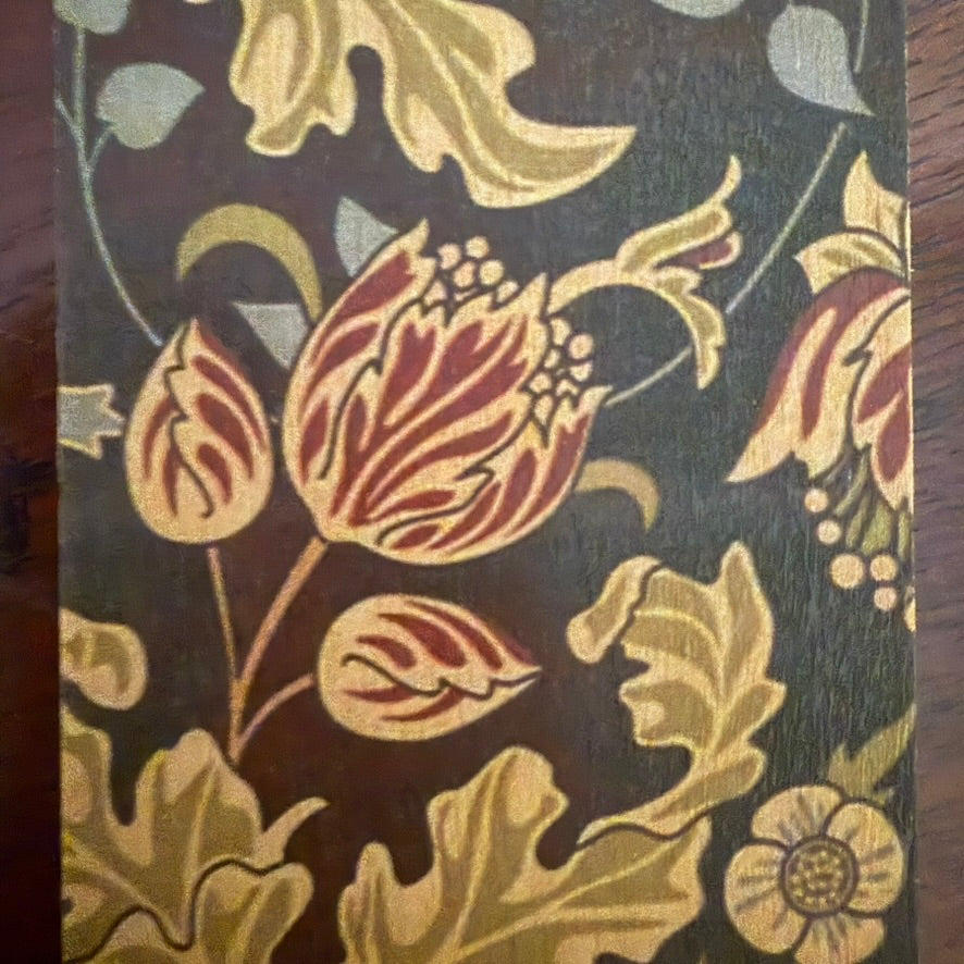 Close-up of dark floral botanical pattern on natural wood bookmark