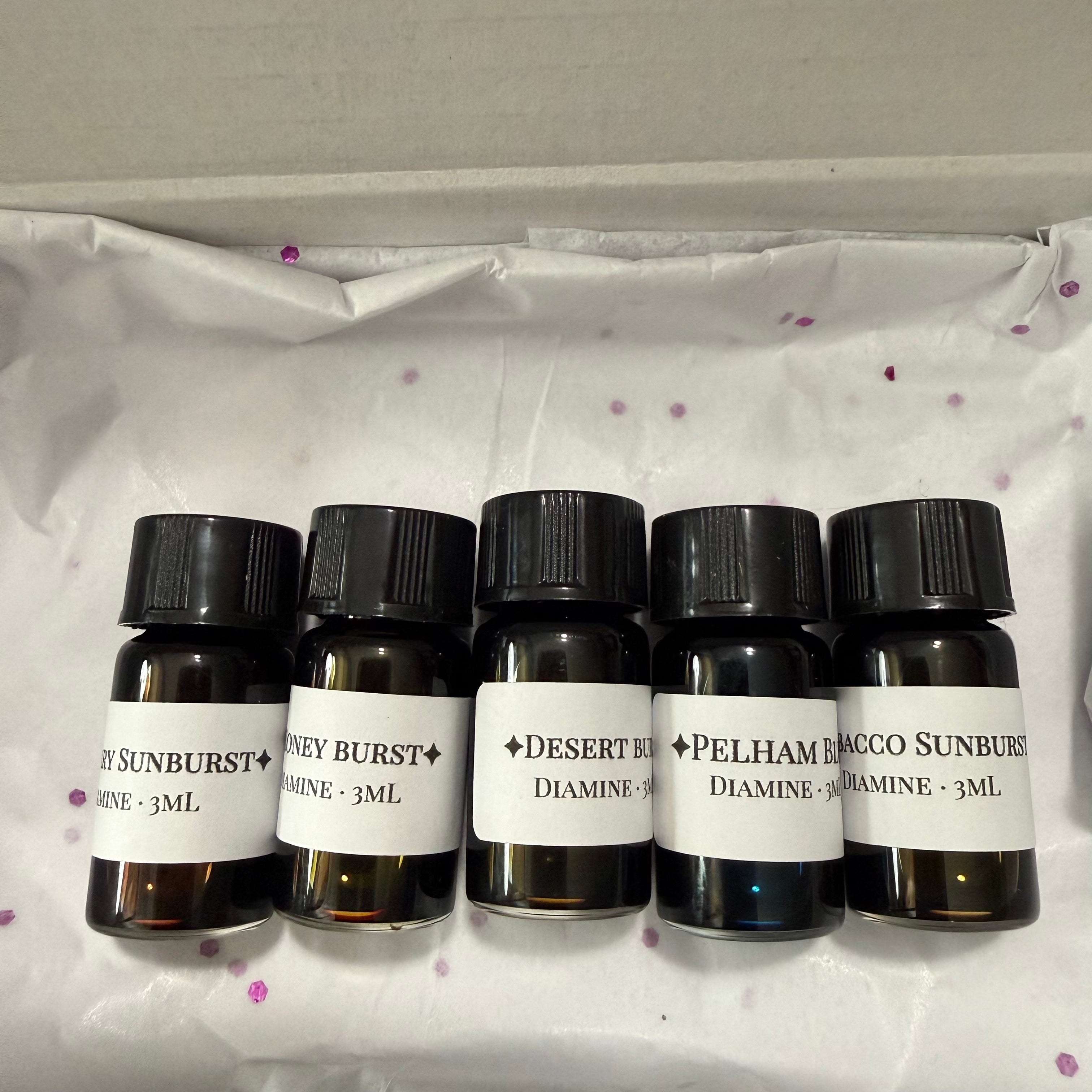Five labeled Diamine Guitar 3 mL ink vials resting on white tissue paper with purple confetti