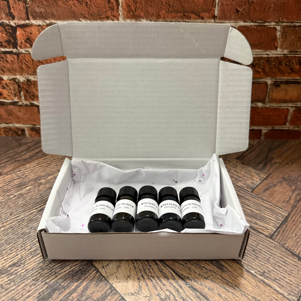 White gift box opened to show the Diamine Guitar 5 × 3 mL ink sampler set on tissue