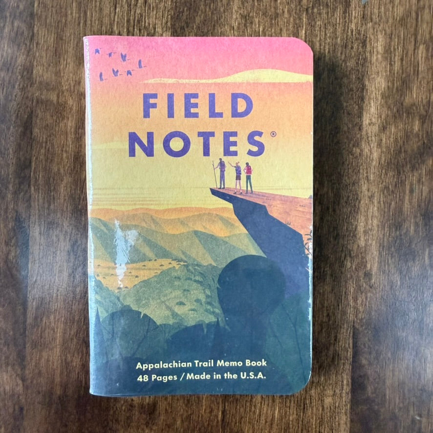 Field Notes Appalachian Trail notebook from the Triple Crown of Hiking three-pack, with hikers overlooking mountains beneath a sunset sky