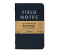 Field Notes Pitch Black pocket notebook with a kraft band reading Ruled Paper, from the 3-pack