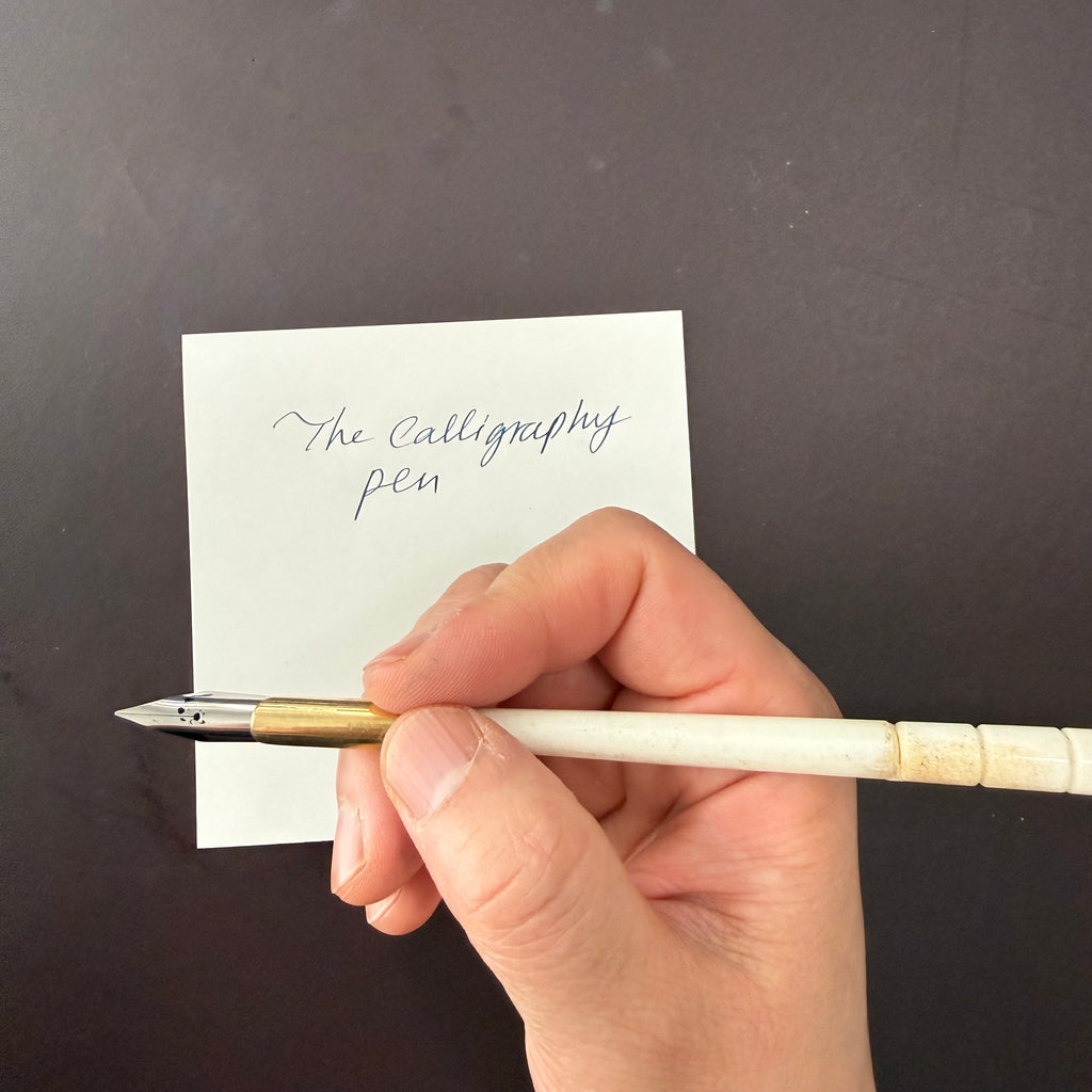 Hand writing calligraphy on a card with the genuine ox bone nib pen