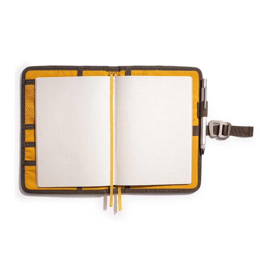 Brown Lochby Field Journal open with its included A5 dot grid notebook and yellow interior pockets