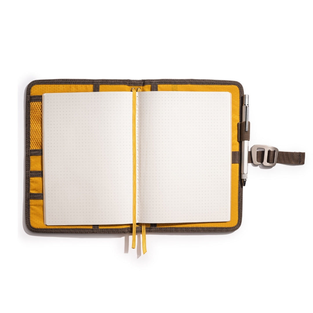Brown Lochby Field Journal open with its included A5 dot grid notebook and yellow interior pockets