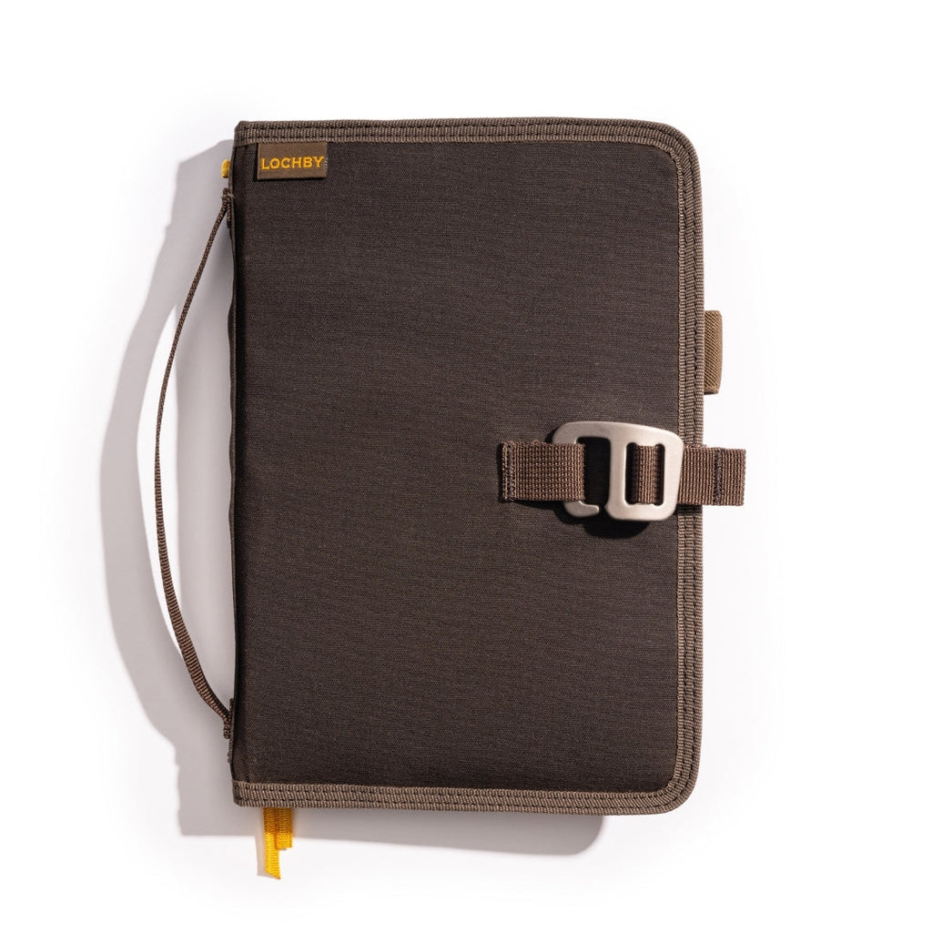Brown Lochby Field Journal closed, showing the waxed canvas cover, hand strap, and metal clasp