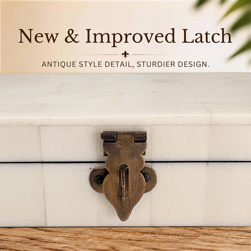 Close-up of the keepsake box’s antiqued brass clasp beneath the supplier’s improved-latch caption