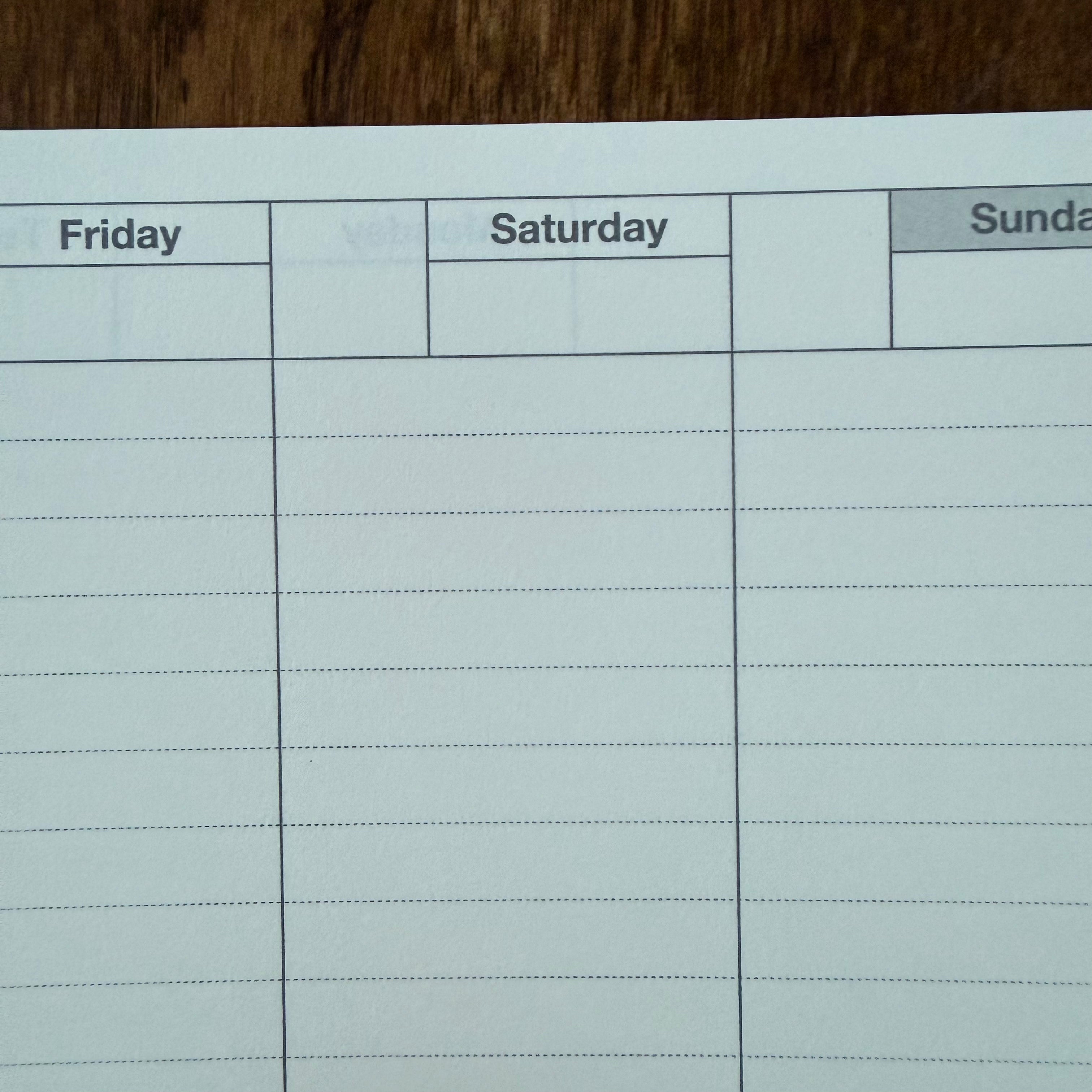 Close-up of the MARK’S Dayfree planner paper, showing Friday, Saturday, and Sunday headings, date boxes, and dotted writing lines.