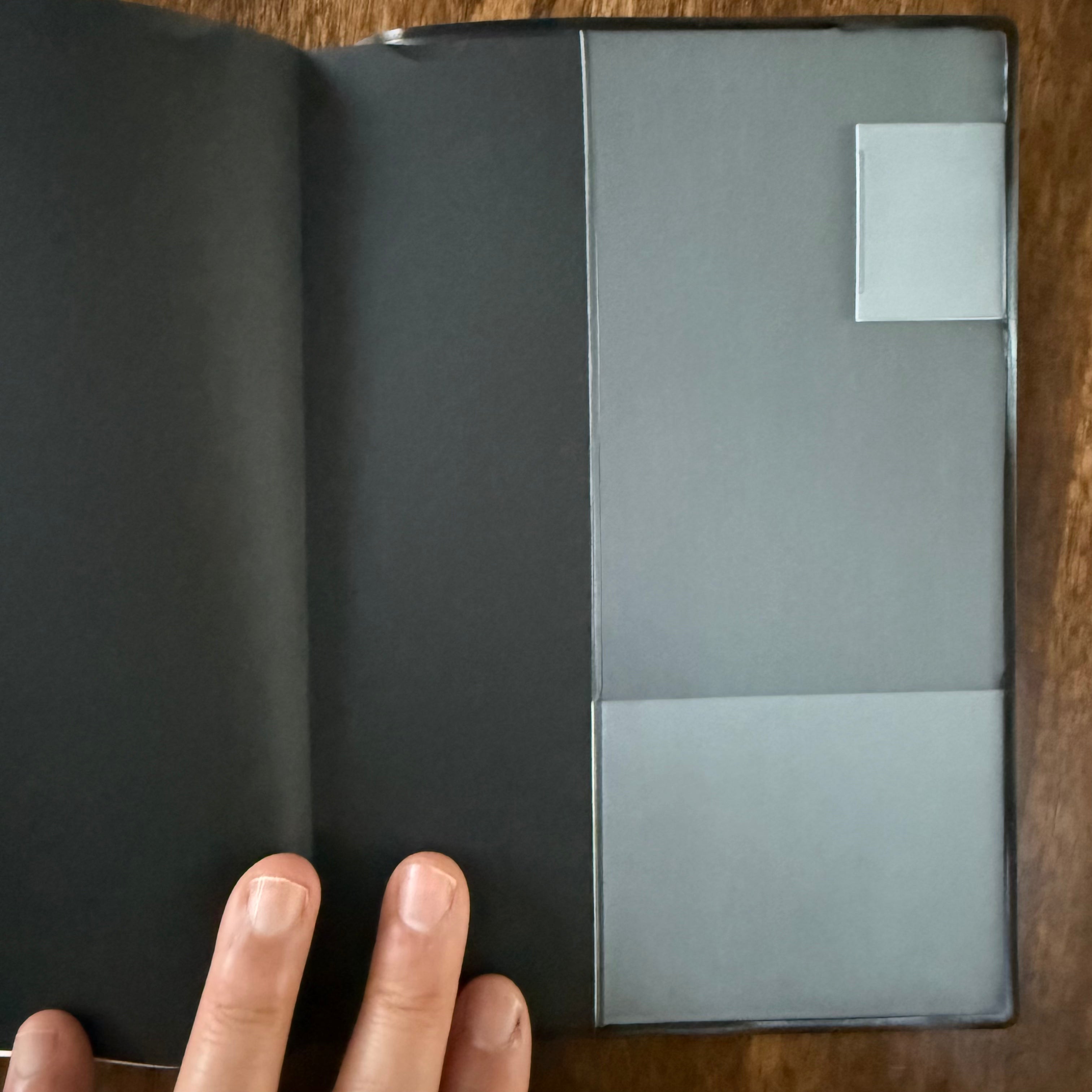 Inside back cover of the MARK’S EDiT B6 Midnight Black notebook, showing the gray notebook cover beneath the translucent PVC sleeve.