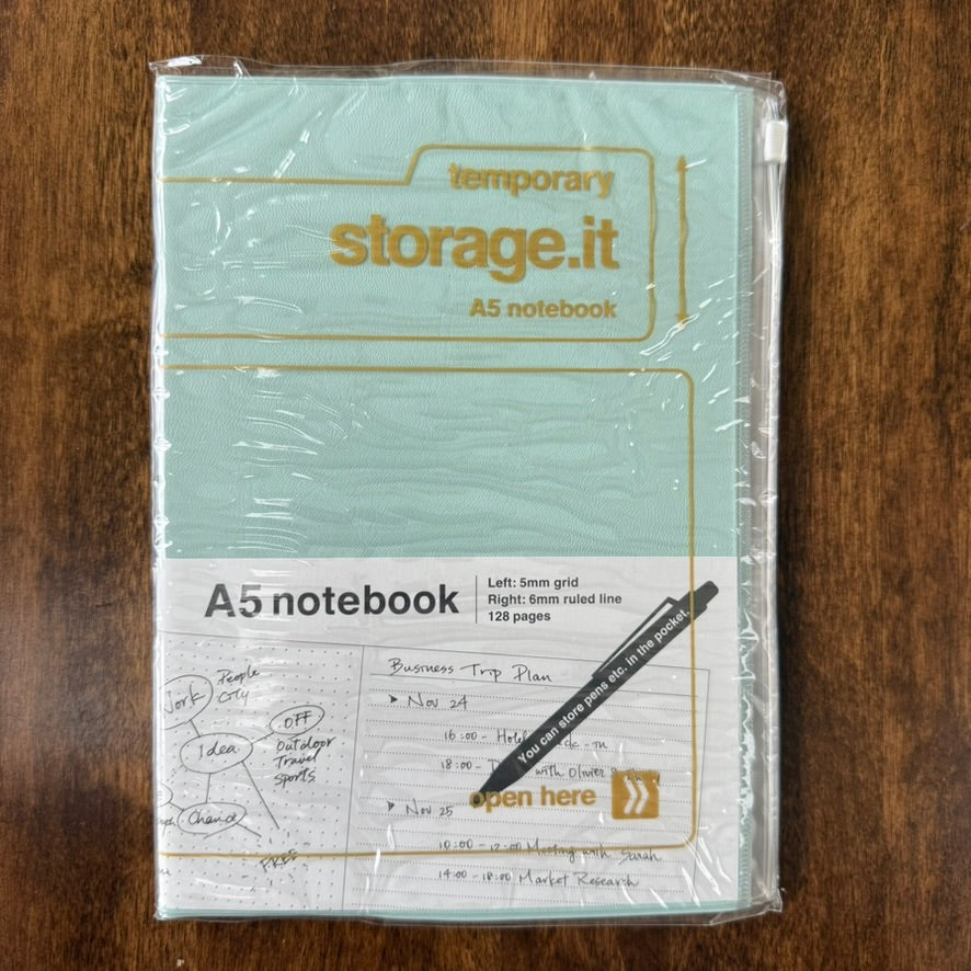 Mint MARK'S Storage.it A5 refillable notebook in retail packaging, with mustard-yellow lettering and a slide-zip storage cover