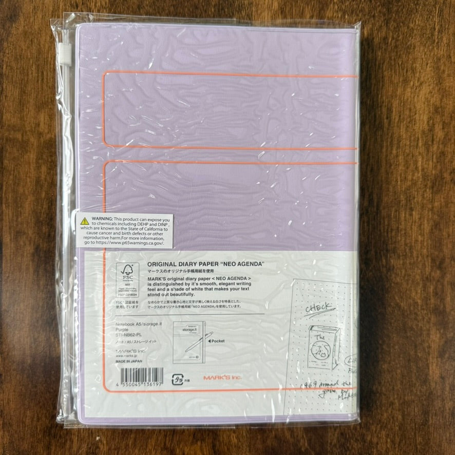 Back of the purple MARK'S Storage.it A5 notebook packaging, showing the NEO AGENDA paper label and slide-zip cover