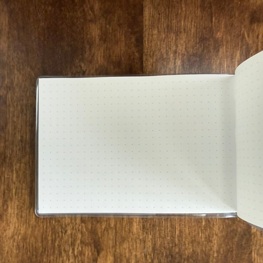 Open MARK'S Storage.it Desk notebook showing blank dot-grid pages in its compact horizontal format