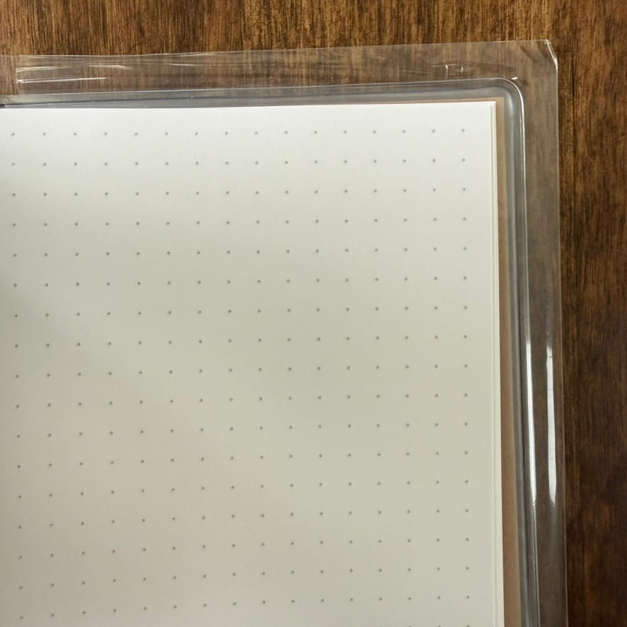 Close-up of the Craft MARK'S Storage.it Desk notebook's pale dot-grid paper and clear cover edge
