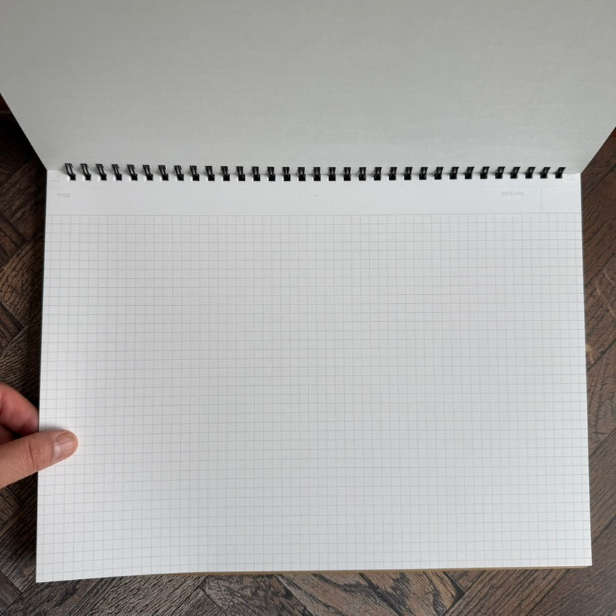 Maruman Mnemosyne A4 landscape notebook open flat with the cover folded back to a full 5 mm grid page