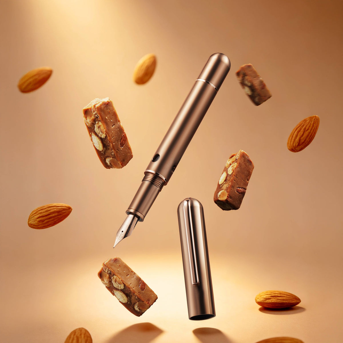Nahvalur Nautilus Ti Toffee titanium fountain pen uncapped among floating toffee and almond pieces