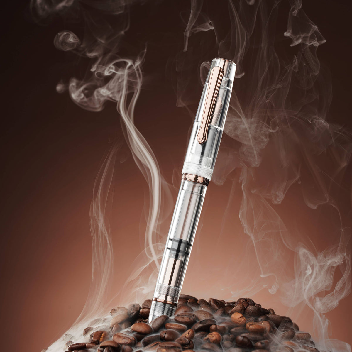 Nahvalur Original Fall clear demonstrator fountain pen standing in coffee beans with rising steam