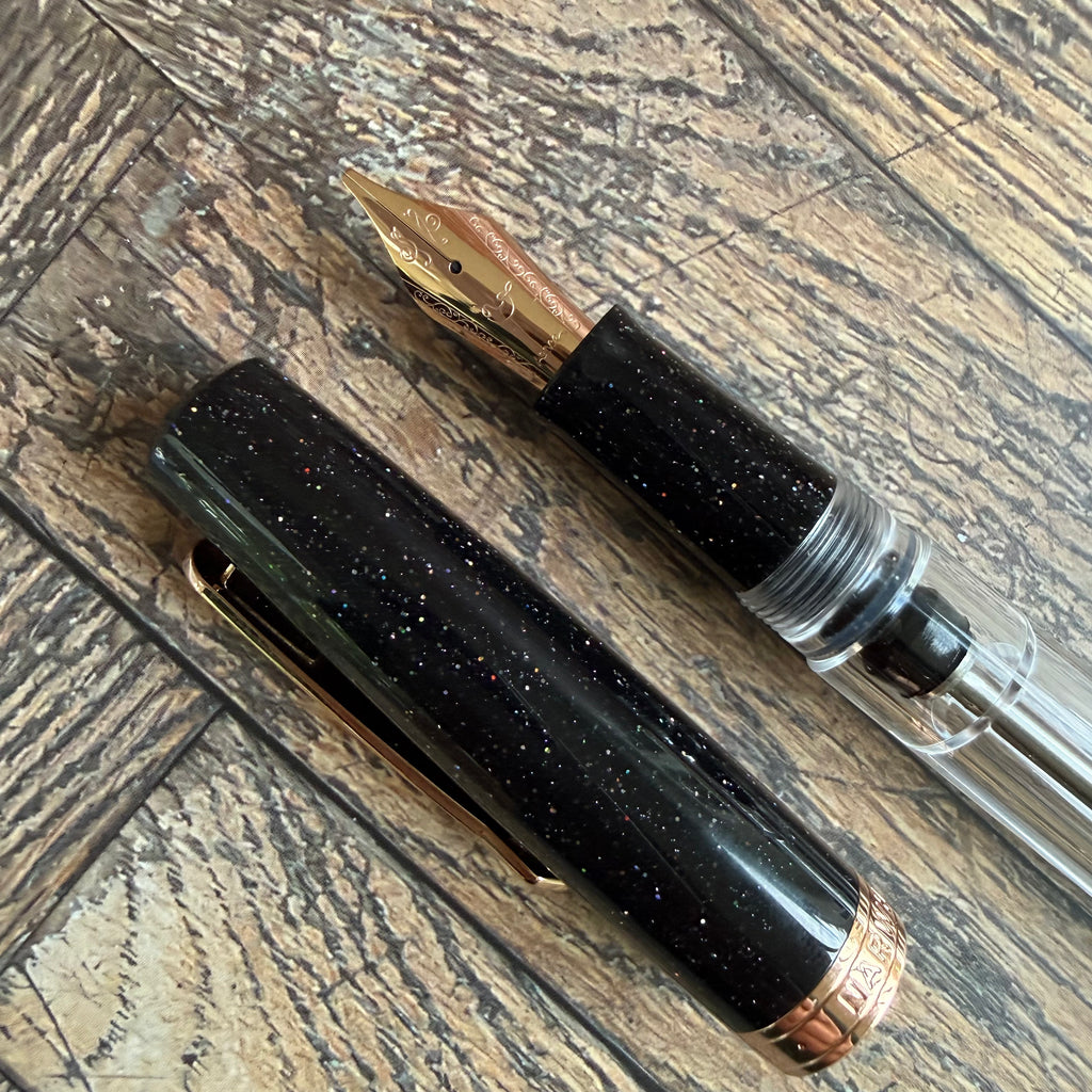 Sparkling black Lovina Graphite cap with rose gold band beside the grip section and nib