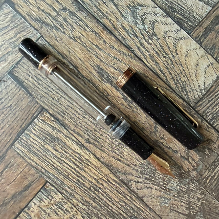 Nahvalur Original Plus Lovina Graphite uncapped, showing the clear demonstrator barrel and vacuum filler