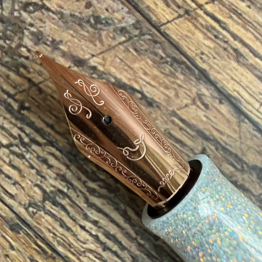 Close-up of the engraved rose gold No. 6 steel nib on the Nahvalur Original Plus Matira Quartz