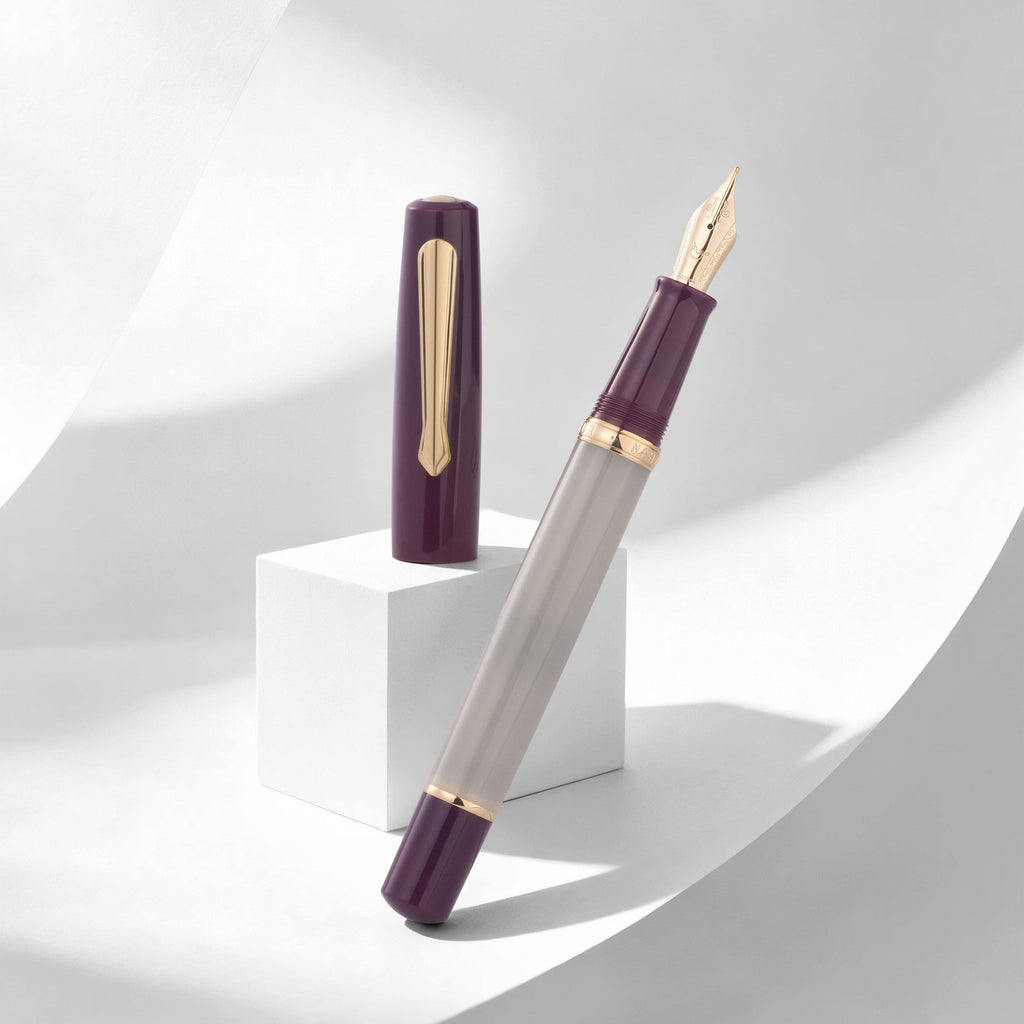 Nahvalur Original Violet Ash fountain pen with a translucent gray barrel, violet cap, and gold-tone trim, uncapped