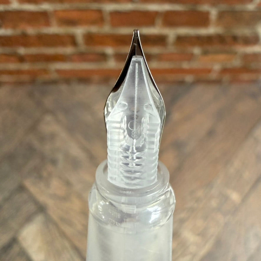 Underside of the Nahvalur Triad nib showing the clear demonstrator feed