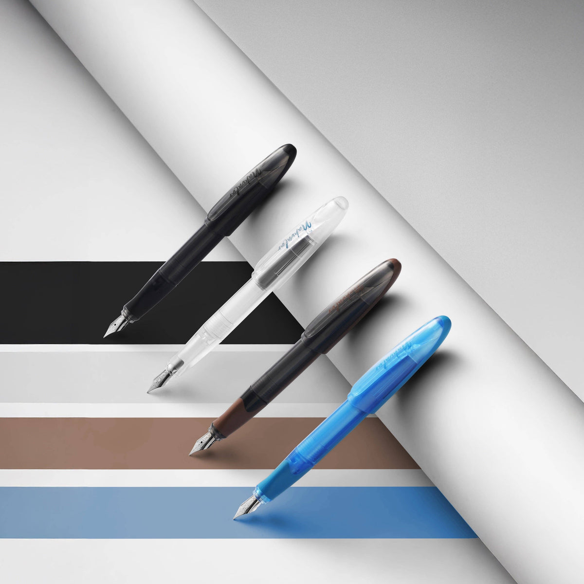Nahvalur Triad fountain pens in black, clear, brown and blue; this listing is the clear demonstrator