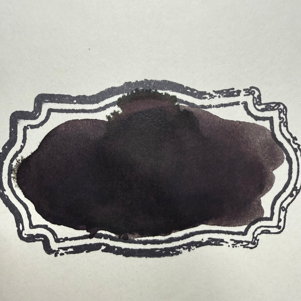 Noodler's Halloween Chuckie fountain pen ink swatch and writing sample, a deep black with a subtle magenta undertone