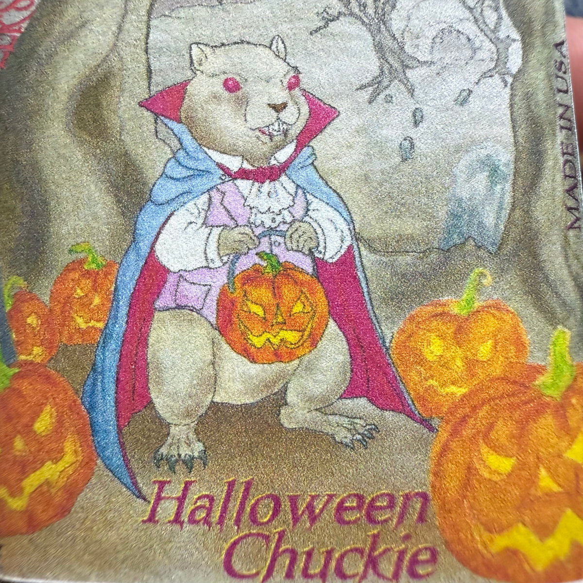 Noodler's Halloween Chuckie label art of a caped creature holding a jack-o'-lantern among pumpkins