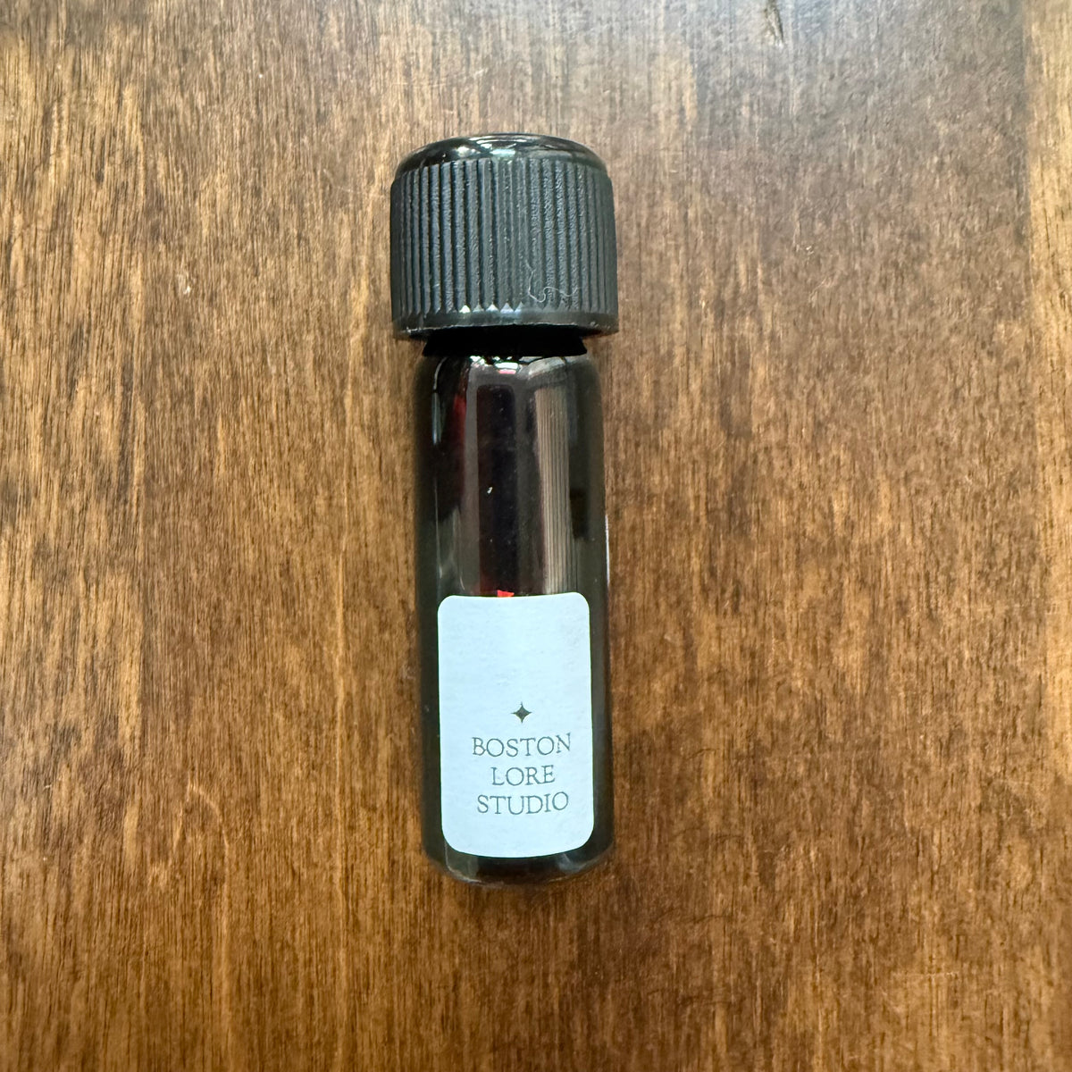 Back view of Organics Studio Edgar Allan Poe 5 mL Archive Bottle showing the Boston Lore Studio label