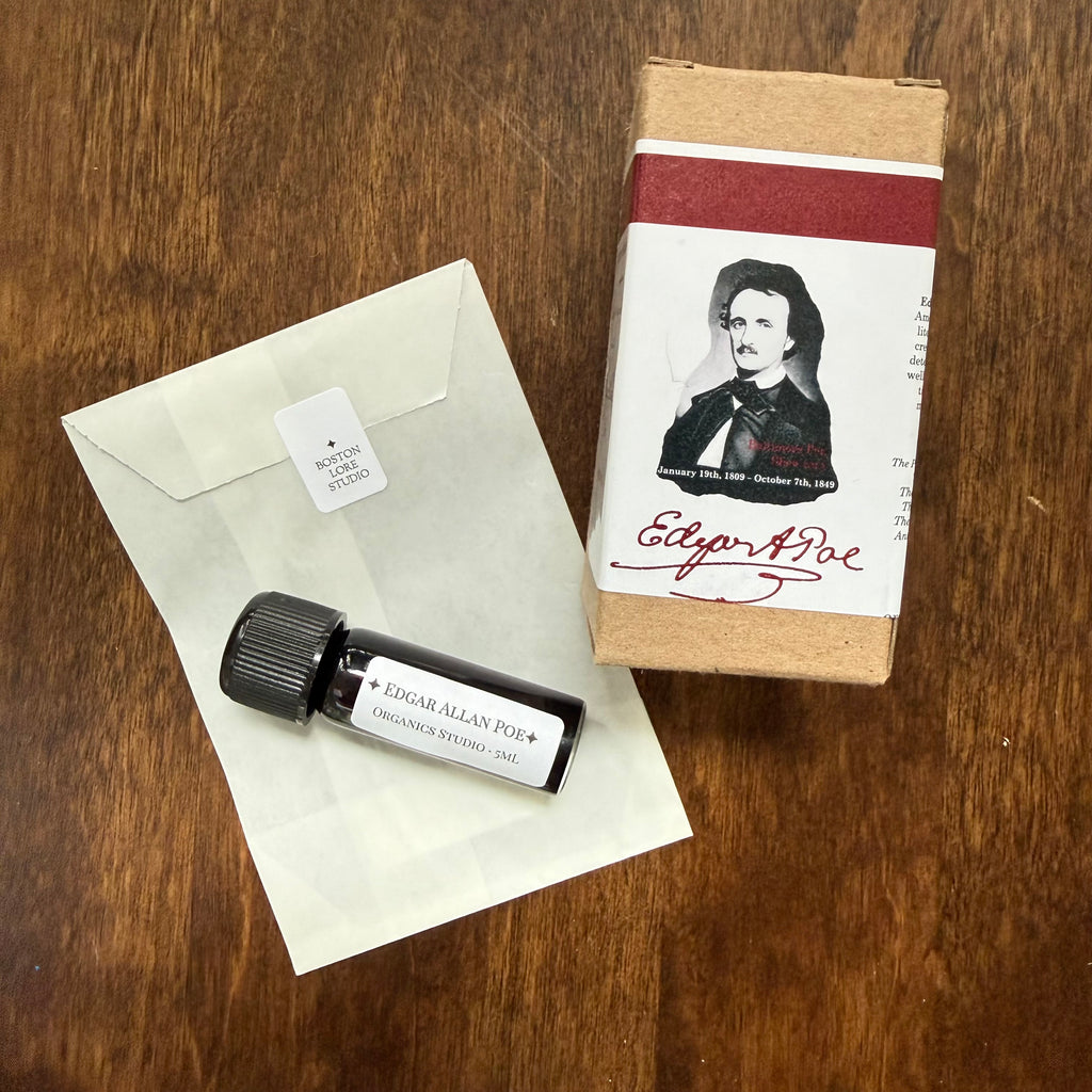 Organics Studio Edgar Allan Poe 5 mL Archive Bottle displayed with a glassine envelope and Poe portrait packaging on a wooden surface