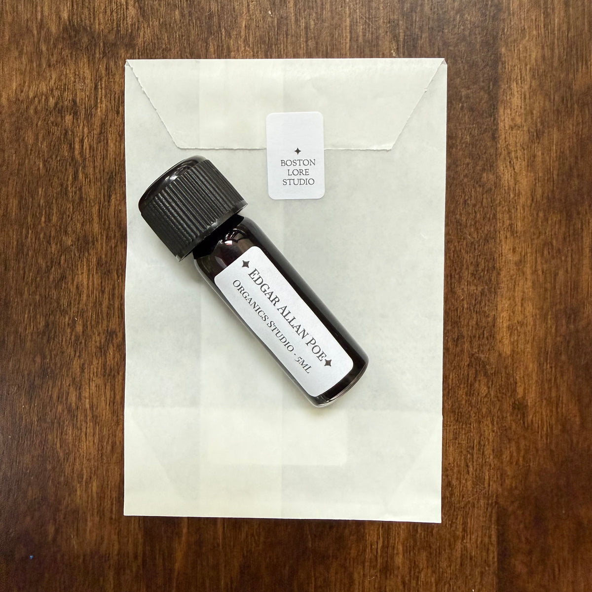 Organics Studio Edgar Allan Poe 5 mL Archive Bottle resting on a labeled glassine envelope