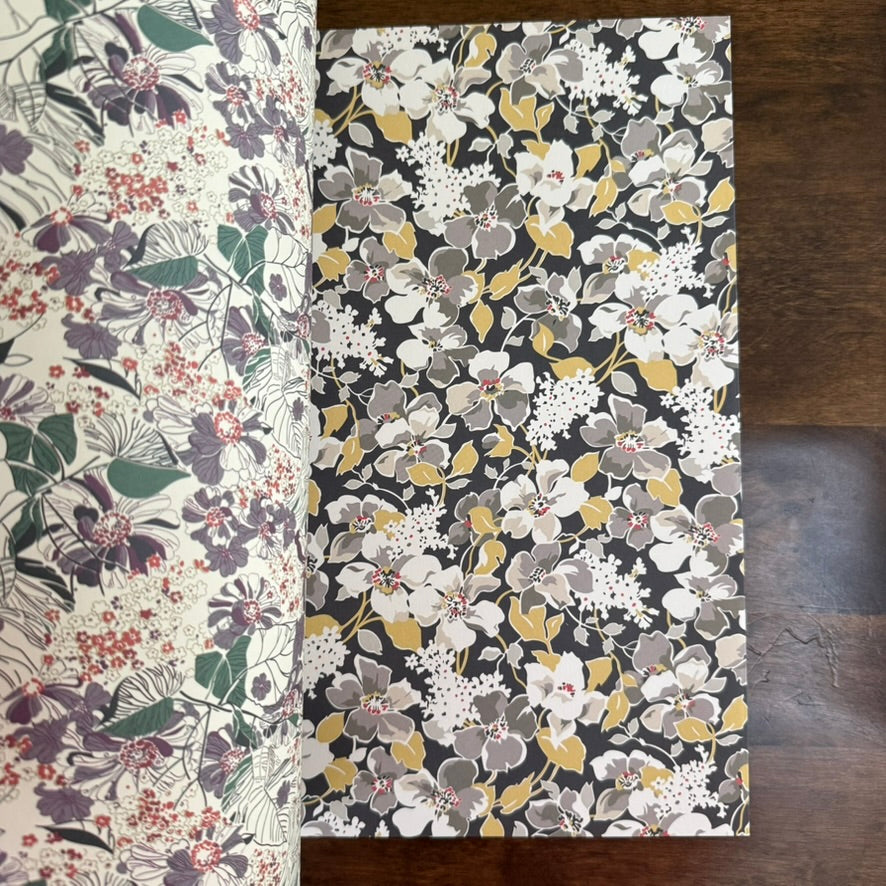 Open PEPIN 1950s Flowers paper book showing grey, cream, green, and plum floral designs