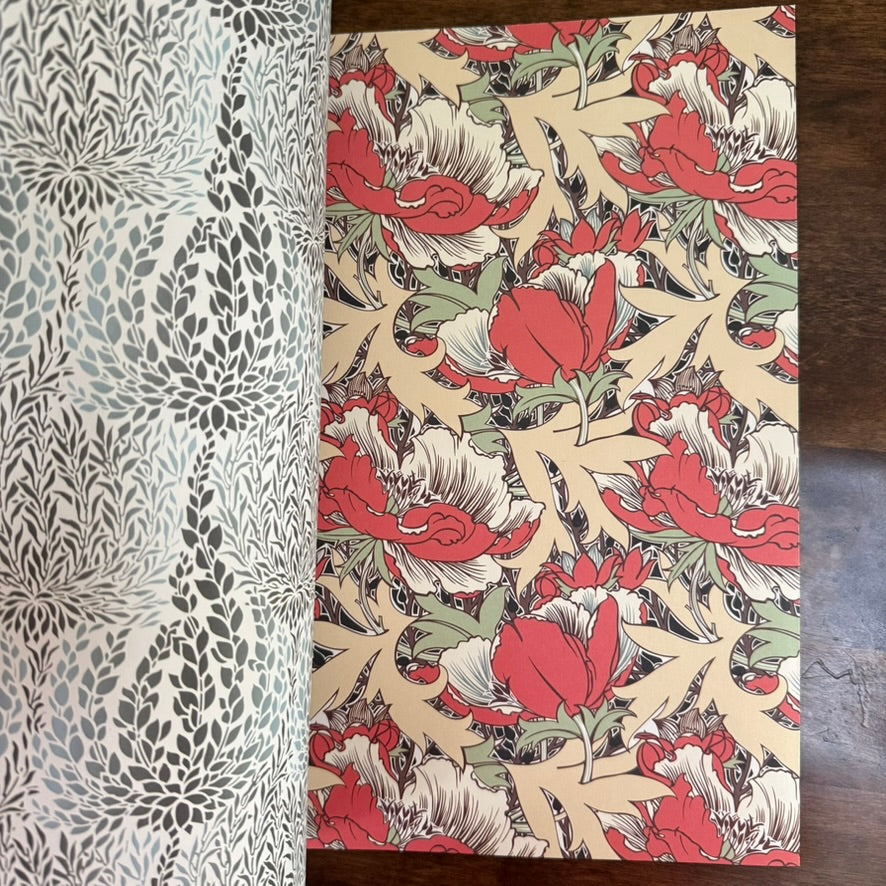 Open PEPIN Arts & Crafts Movement paper book showing red floral and monochrome foliage designs